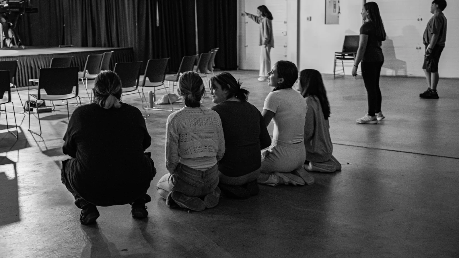 A youth group sits together in a circle.